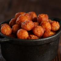Sweet Potato Tots · Vegetarian. Crispy on the outside, tender and sweet on the inside. Served with a side of sri...