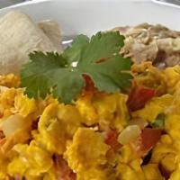 Huevos Rancheros / Eggs Ranch Style · Con arroz y frijoles. / With rice and beans.