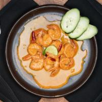 Spicy Garlic Prawns · Tiger prawns sautéed with garlic, butter, lime, beer, and authentic spices.