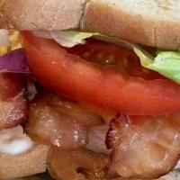 Turkey Club Sandwich · Turkey, bacon, cheddar cheese, tomato, red onion, mayo and dijon mustard on your choice of b...