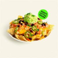 Vegan Nachos · Tortilla chips layered with gooey vegan cheese, pico de gallo, guacamole, black beans, and j...