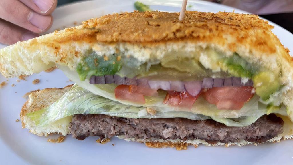 Cali Burger · 8 oz beef or veggie patty served with Swiss cheese, avocado, red onion, tomato and sprouts on a toasted Parmesan sourdough.