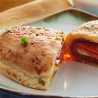 Pepperoni And Mozzarella Calzone · Lots of Pepperoni and Mozzarella cheese stuffed and folded inside Pizza Dough. Served with M...