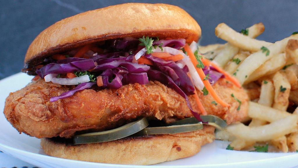 The Clucker · Hand-breaded fried chicken breast, jicama citrus slaw, Clucker's aioli, house made pickles, all on a fresh baked roll. Comes with a side of our hand cut sea salt fries.