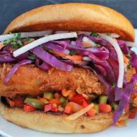 The Spicy Cluck · Spicy AF fried chicken breast, jicama citrus slaw, pickled hot peppers, Clucker's aioli, all...