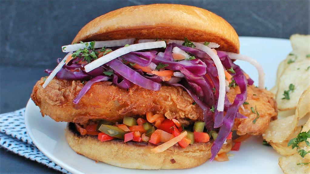 The Spicy Cluck · Spicy AF fried chicken breast, jicama citrus slaw, pickled hot peppers, Clucker's aioli, all on a fresh baked roll. Comes with a side of our hand cut sea salt fries.
