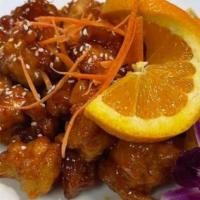 Orange Chicken · Deep-fried chicken in orange sauce and sesame seed, served with cabbage, broccoli and carrots.