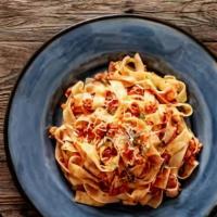 Fettuccine Bolognese · Fresh Fettuccine in marinara sauce and meat sauce.