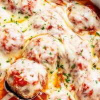Meatball Dish · Oven-baked meatballs with meat sauce topped with mozzarella & parmesan cheese.
