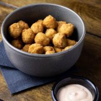 Popcorn Chicken · Breaded chicken bits served with a side of spicy mayo.