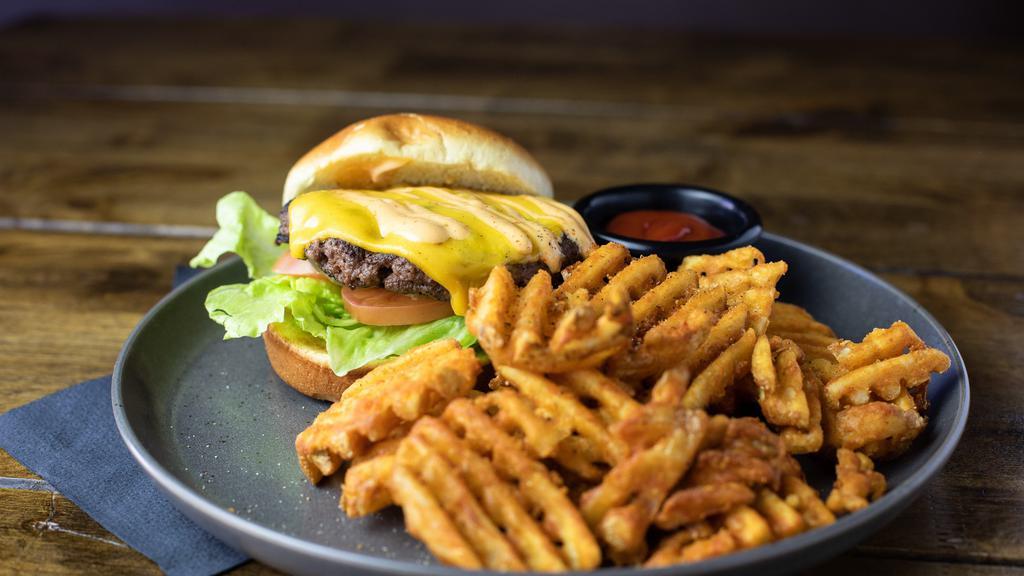 America Burger · American, tomato, lettuce and pickle served on a brioche bun. served with a side of waffle fries.