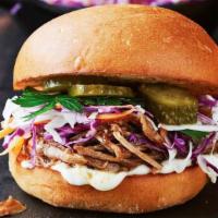 Bbq Pulled Pork · House made and slow roasted! Topped with pickles and cole slaw.