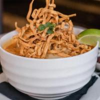 Khao Soi · Northern thai style curry broth with egg noodles and shredded chicken, served with pickled m...