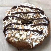 Samoa · Vanilla Cake donut topped with our caramel glaze, shredded coconut and a chocolate drizzle.