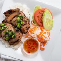Cơm Gà Nướng · Marinated grilled chicken served with broken rice, carrot and daikon, and sliced cucumber an...