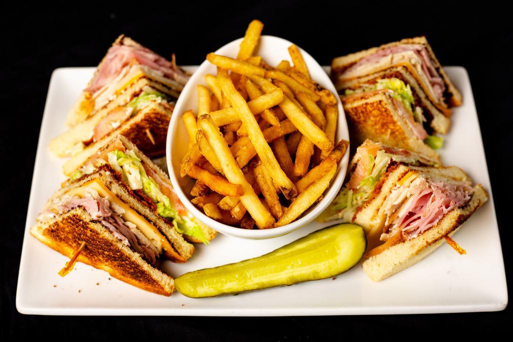 Club Sandwich · Sliced ham and turkey with bacon, lettuce , tomato, cheddar cheese, swiss cheese and mayonnaise,  stacked between three pieces of toasted bread.