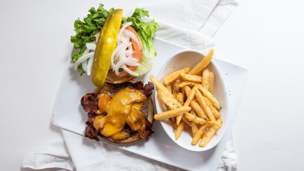 Bacon Cheeseburger* · Our signature sirloin patty topped with two strips of bacon, cheddar cheese, lettuce, tomato, onion and mayo.
