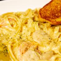Seafood Fettuccini · Sautéed prawns and scallops tossed together in a creamy alfredo sauce with fettuccini noodle...