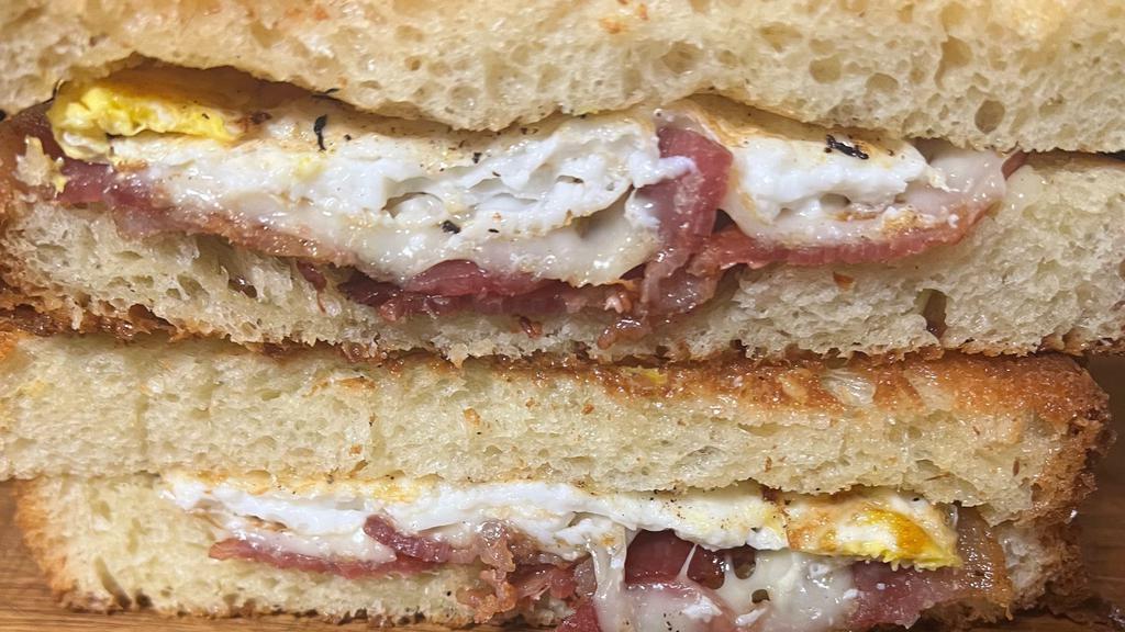 Big Bussin · Toasted sourdough with egg, pepper jack cheese, crispy hash browns and grass fed sausage, grass fed bacon and our signature Taylor ham.
