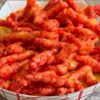 Hot Cheetos With Nacho Cheese · A large plate of hot cheetos with steaming hot nacho cheese.