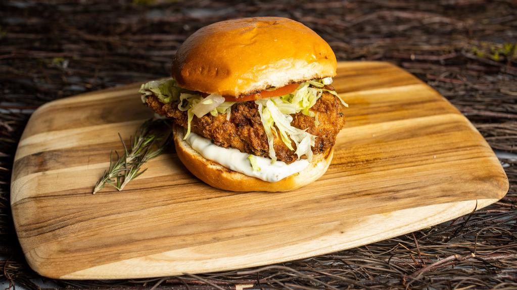 Classic Fried Chicken Sandwich · Dish out on crispy fried chicken with caper aioli, lettuce, and tomato