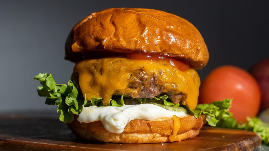 Cheese Burger · Beef patty, lettuce, tomato, onion, mayo, and melted cheddar cheese on a warm classic bun