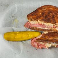Reuben · Fresh Marble Rye buttered and grilled, freshly sliced Corned Beef, Sauerkraut, melted Swiss ...