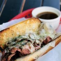 French Dip · Thinly sliced Pastrami and melty Swiss Cheese on a Hoagie roll served with a cup of Au Jus.