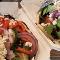 Gyro · Grilled Gyro meat or Chicken stuffed in a warm Pita with fresh Spring Mix, Tomatoes, Cucumbe...