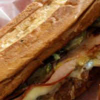 Cuban · Tender and juicy pulled Pork, Black Forest Ham, Swiss Cheese and Pickles with Mayo and Musta...