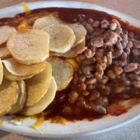 Huevos Rancheros · Two eggs on corn tortilla with beans and rice, smothered with cheese and red or green Chile ...