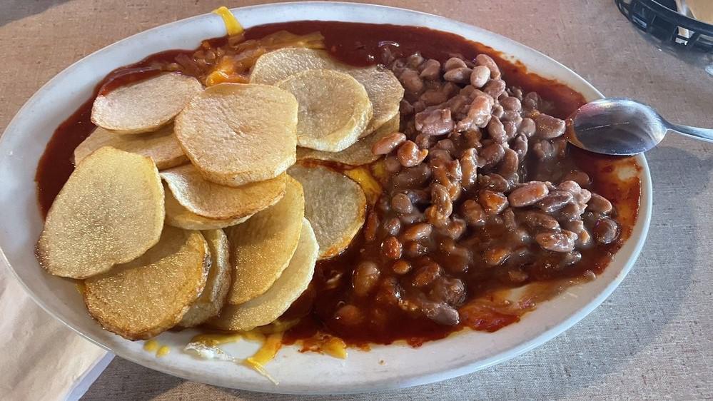 Huevos Rancheros · Two eggs on corn tortilla with beans and rice, smothered with cheese and red or green Chile served with flour tortilla on the side; may substitute rice for hash browns or home fries.