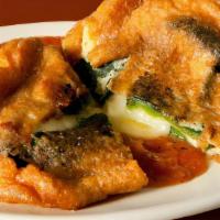 Chiles Rellenos (2) · Roasted crispy poblano peppers stuffed with Oaxaca cheese. Served with rice and beans.