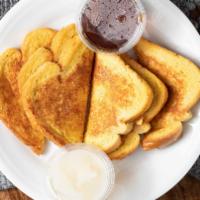 Sourdough French Toast · Slices of sourdough bread dipped in our egg batter, sprinkled with powdered sugar, and grill...