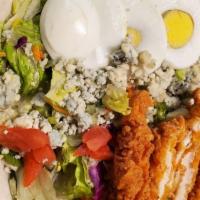 Cobb Salad · House mixed greens topped with crumbled bleu cheese diced tomatoes, warmed chopped bacon, ha...