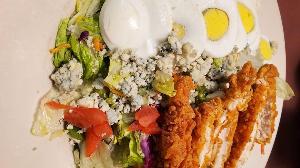 Cobb Salad · House mixed greens topped with crumbled bleu cheese diced tomatoes, warmed chopped bacon, hard cooked egg marinated and grilled chicken breast served with a creamy buttermilk ranch dressing