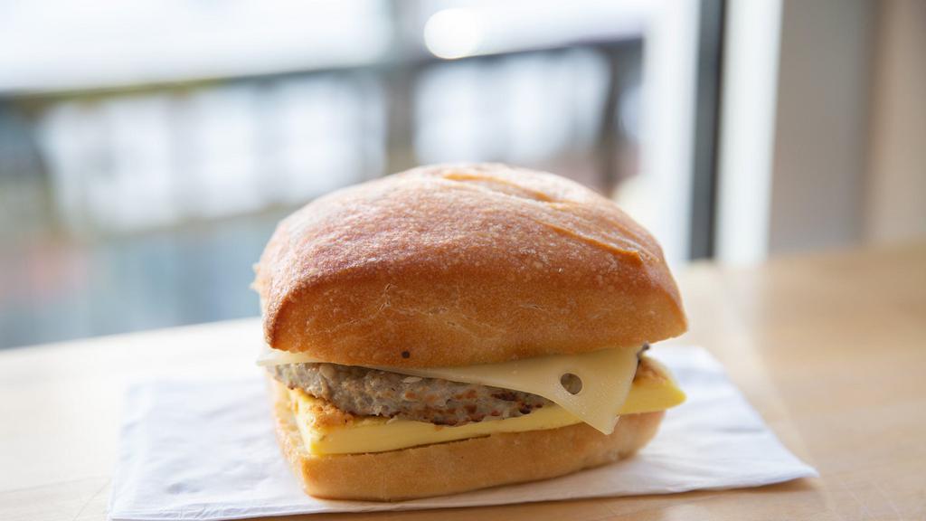 Sausage Breakfast Sandwich · Nitrate free sausage patty, sharp white cheddar and a cage free egg toasted on ciabatta with roasted garlic aioli.