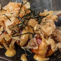 Takoyaki (6Pcs) · grilled pancake in the shape of a round ball with a piece of octopus in a soft center.