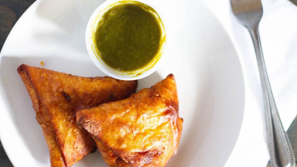 Vegetable Samosas · Traditional indian crispy filled pastry filled with potatoes, peas, and spices. 2 pieces.