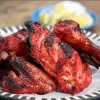 Tandoori Wings · Tandoori wings mildly spiced with ginger and mint, then baked in our tandoori oven.