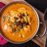 Butter Chicken · Chicken breast cooked with extra garlic, ginger, and spices in a thick creamy curry sauce.