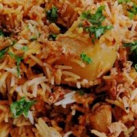 Chicken Biryani · Basmati rice cooked with chicken, fresh garlic, ginger, onions, nuts and spices.