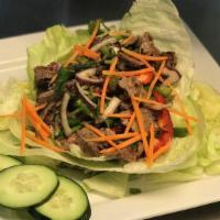 Nam Tok (Beef Waterfall Salad) · Sliced beef with onions roasted rice powder, lime juice, chili powder, green onions, tomatoe...