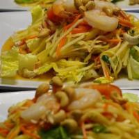 Seafood Salad · A mixture of shrimp, crab meat, calamari, cilantro, green and red onions, topped with a spic...