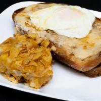 Croque Madame · A croque monsieur (Ham and gruyère on grilled French bread with mornay sauce) with egg.