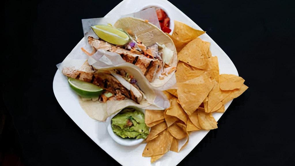 Fish Tacos · Fish tacos choice of panko breaded and fried or chargrilled mahi-mahi topped with cranberry jicama slaw, and lime squeeze.