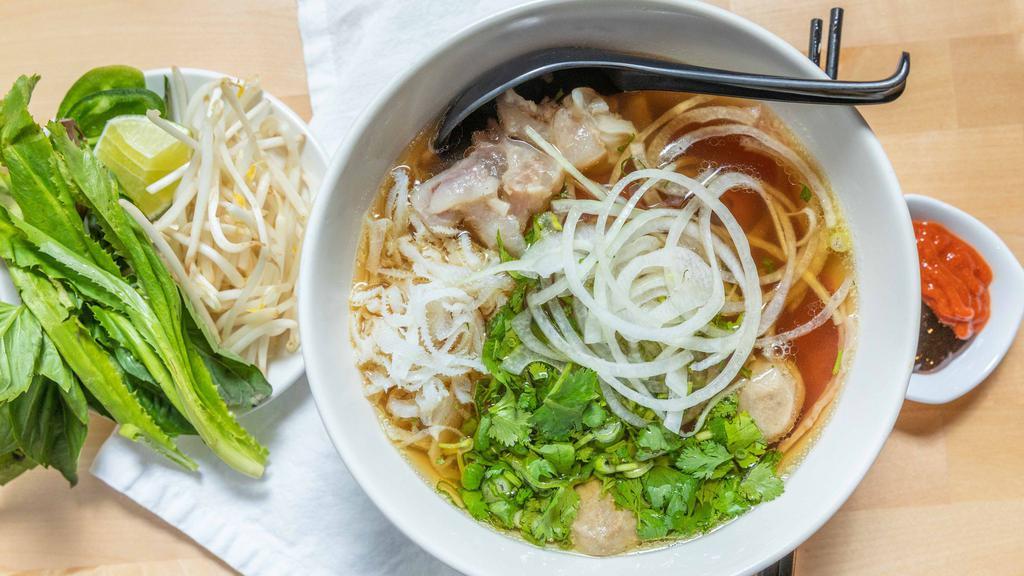 Pholandia Special · Braised beef broth & gluten-free rice noodles, sliced flank, round steak, shank, tendon, tripe, meatballs, green onion, cilantro, white onion; served with basil, bean sprouts, lime