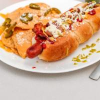 Sonoran Hotdogs · Sausage rolled in bacon and topped with pinto beans, ketchup, mustard, diced tomatoes, onion...