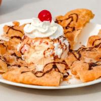 Sopapilla · Deep fried triangles of pastry dough, covered in sugar/cinnamon,then topped with chocolatte ...