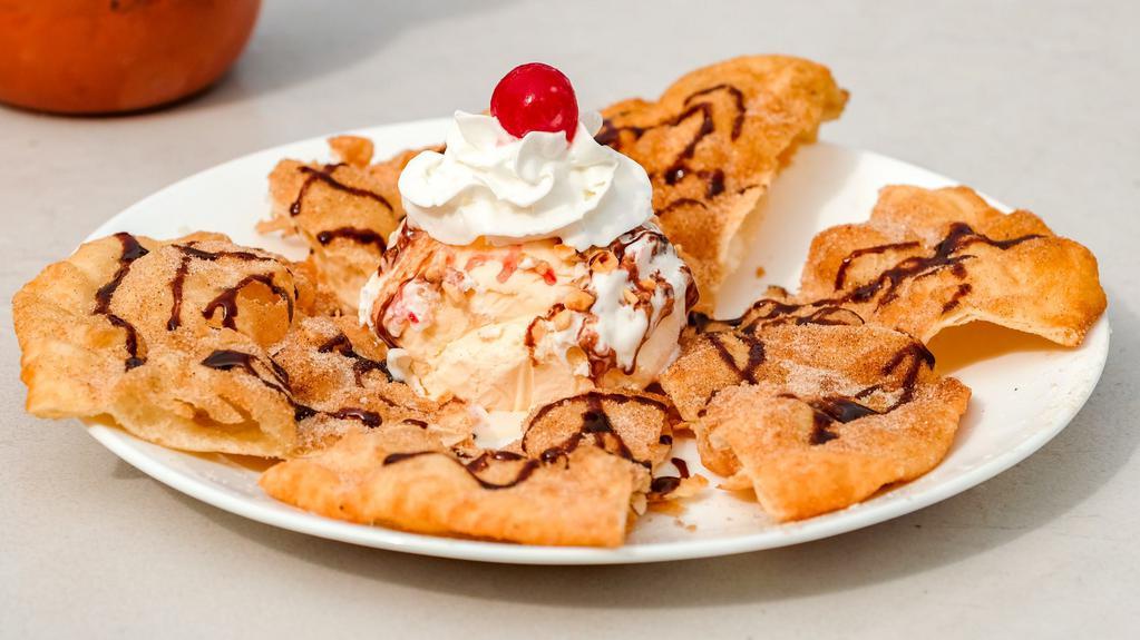 Sopapilla · Deep fried triangles of pastry dough, covered in sugar/cinnamon,then topped with chocolatte or strawberry and accompanied by vanilla ice cream